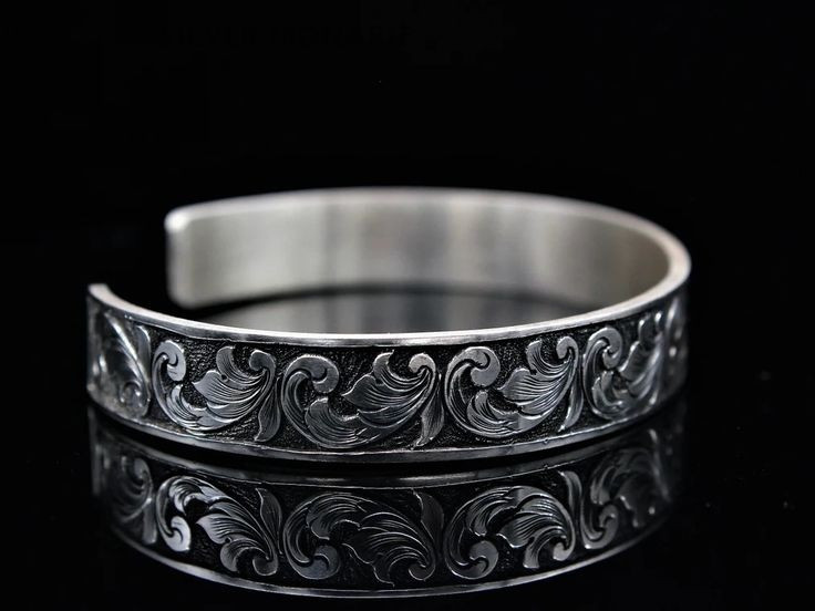 Серебряный браслет с изысканным объемным узором на черном фоне