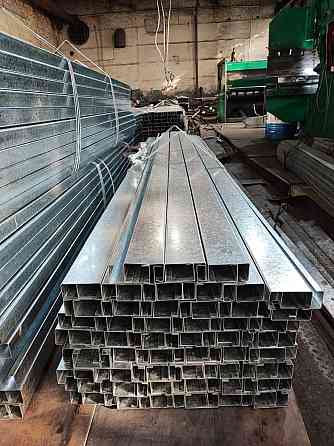 Стacks of galvanized metal profiles in a workshop