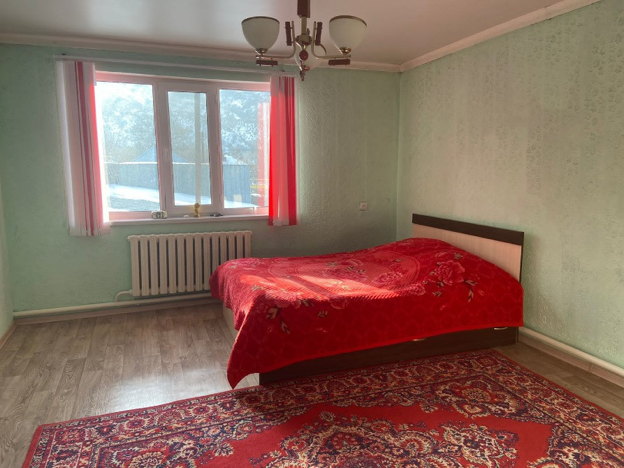 Көшеге шығатын терезелері бар жатын бөлме