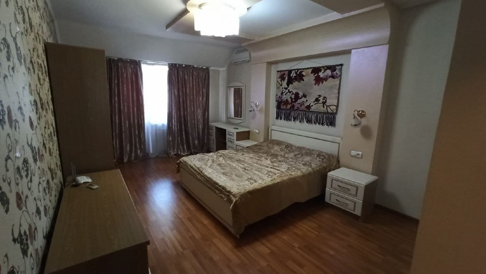 Спальня с двуспальной кроватью и зеркалом