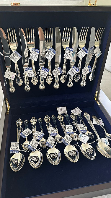 Комплект столовых приборов с ложками, вилками и ножами в коробке с ценниками