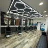 Заманауи барбер шоп ерекше жарықпен және стильді интерьермен
