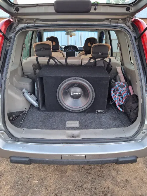 Салон автомобиля с установленной аудиосистемой, вид на сабвуфер в багажнике