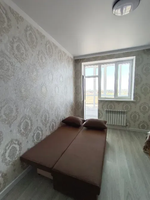 Спальня с раскладным диваном и большим окном