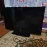LG телевизоры, алдыңғы көрінісі, үстелде орнатылған