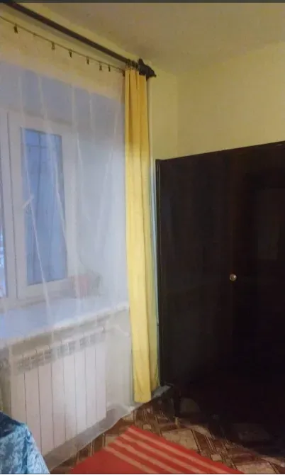 Сары перделер мен есігі бар терезе