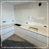 Ақ шкафтарды және сұр үстелшені қамтитын асүй