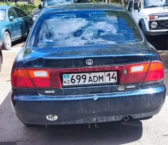 Автомобиль вид сзади с номером 699ADM14