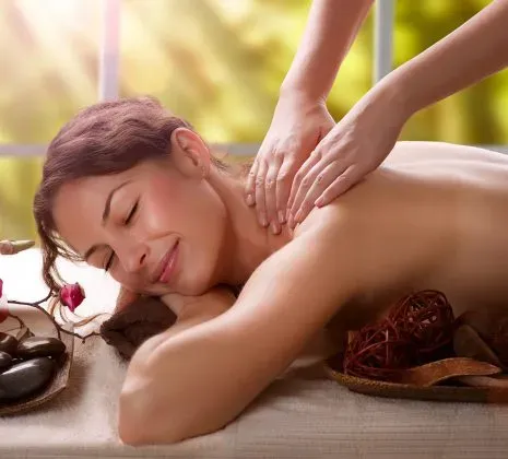 Женщина наслаждается расслабляющим массажем на фоне природы