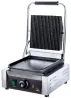 Антипригарлы қаптамасы бар электр гриль, реттелетін термостаты бар. Тік рельефтері бар грильдің алдыңғы көрінісі.