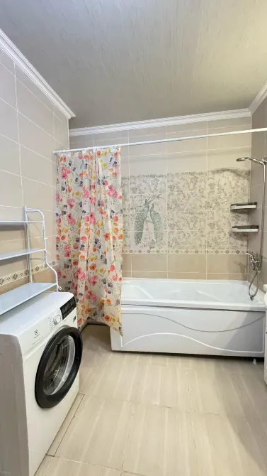 Ванная комната с ванной и стиральной машиной