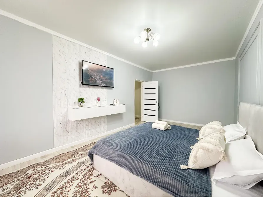 Спальня с диваном, телевизором и современным интерьером