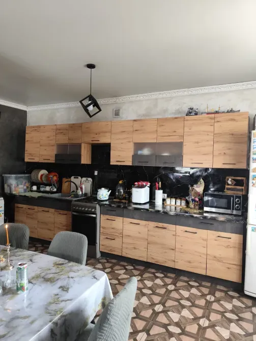 Кухня с деревянными шкафами и плитой