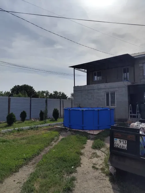 Загородный дом с голубым бассейном на заднем дворе