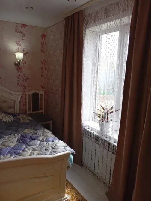 Терезесі және пердесі бар жатын бөлме