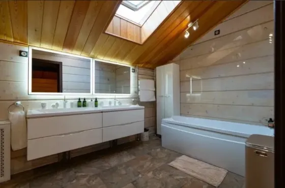 Бассейн на открытом воздухе с вечерним освещением и деревянным домом на фоне