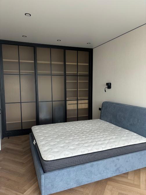 Уютная гостиная с серым диваном и светлыми стенами