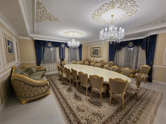 Просторная и элегантная столовая с мебелью из темного дерева и красивым освещением