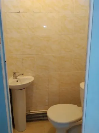 Длинный коридор с дверью и полкой для хранения