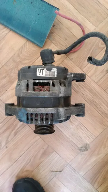 Ағаш еденнің фонында сымдары бар автокөлік генераторының түрі