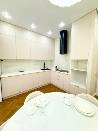 Современная спальня с мягким текстилем и стильной люстрой