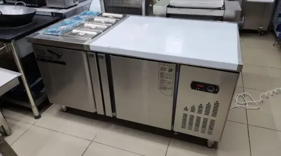 Холодильный стол для кухни с металлическим корпусом и несколькими ящиками для хранения продуктов