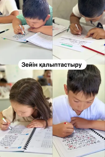 Балалар тобы дәптерлерінде графикалық тапсырмаларды және суреттерді орындап, шоғырланған