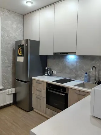 Заманауи шкафтары мен күміс тоңазытқышы бар асхана