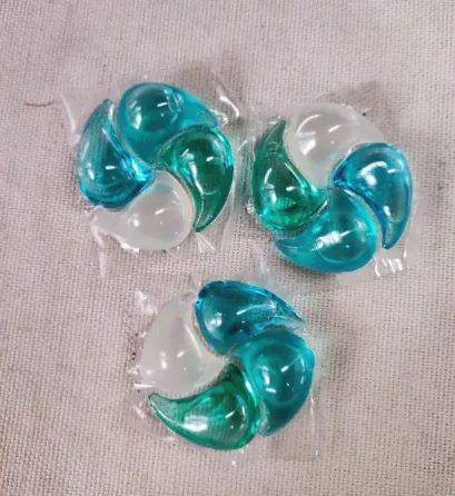 пакет с капсулами для стирки в руке