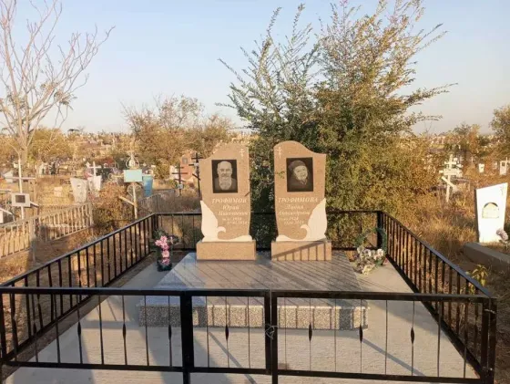 Кладбище с двумя памятниками и цветами