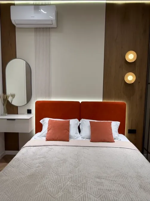 Төсек, жастықтар мен көрпелер қабырға фонында