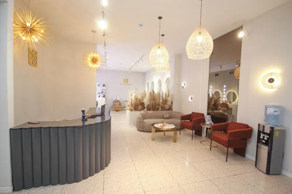 сұлулық салонында ыңғайлы диванмен және декоративті элементтерімен кең қабылдау