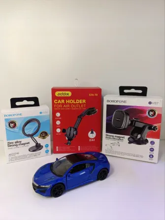 Модель автомобиля на фоне упаковок зарядных устройств и автомобильных аксессуаров