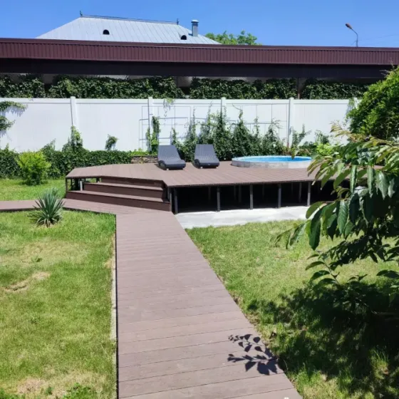 Пешеходная дорожка из дерева на травяном участке