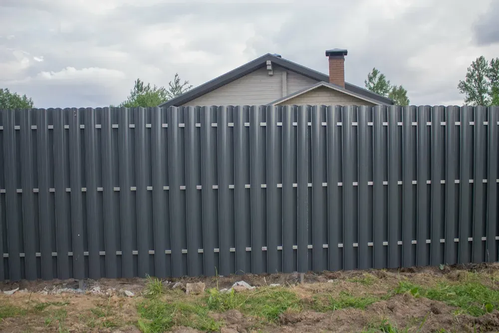 Биік жақтан кіру мүмкіндігі жоқ біртекті сүр шарбақ орманның фонында