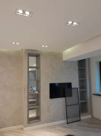 ремонт в комнате с черной и белой краской, рядом ведра и мешки с мусором