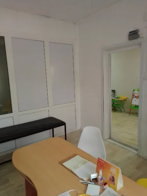 Уютный офис с письменным столом и растением