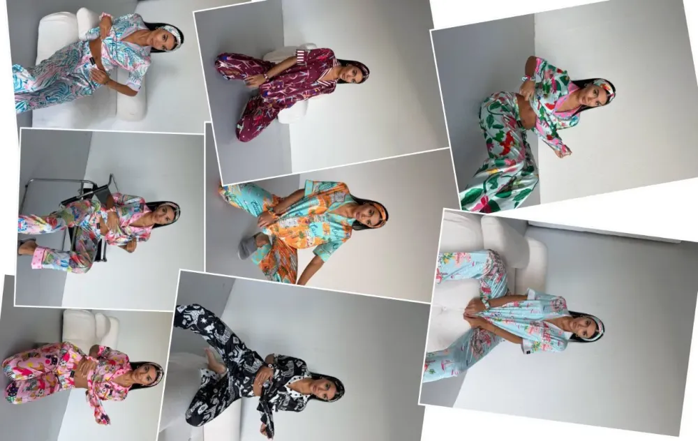 Стильная женщина в яркой одежде, позирующая на фоне светлой стены