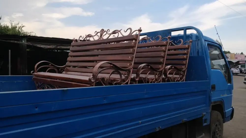 Грузовой автомобиль с деревянными скамейками на кузове