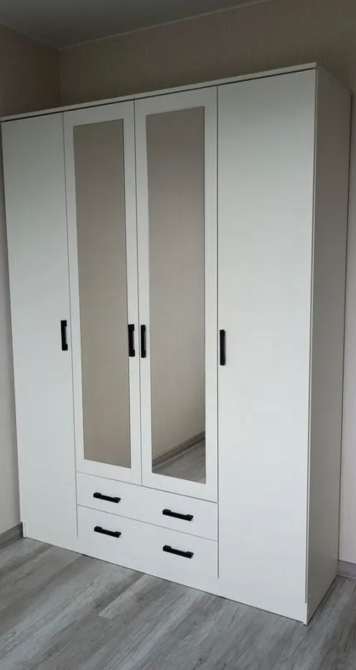 Белый трехдверный шкаф с зеркалом и выдвижными ящиками