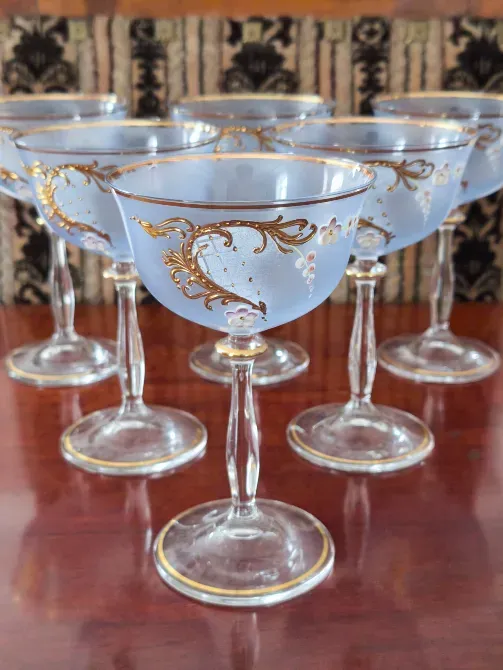 Шестигранные десертные бокалы с золотым декором на деревянной поверхности