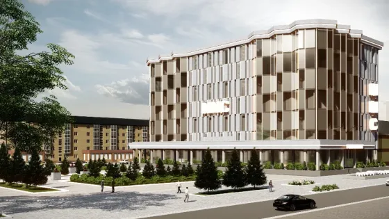 Современное здание с уникальной архитектурой и зелеными насаждениями на переднем плане