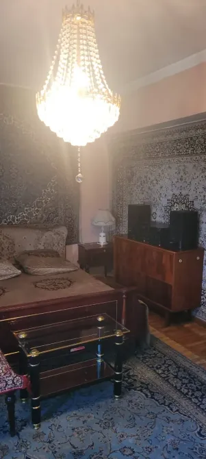 Спальня с кроватью, телевизором и люстрой