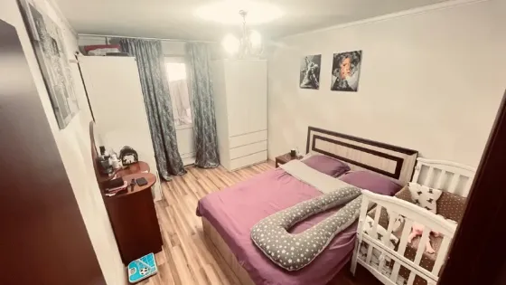 Спальня с детской кроваткой и диваном