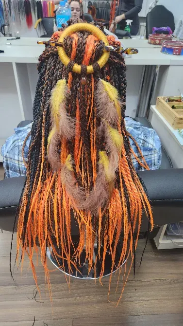 Прическа с длинными яркими косами и аксессуарами из фиолетовых и оранжевых прядей