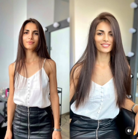 Ұзын шашты қыз ақ көйлекте, стайлингсіз шаш үлгісін көрсетіп, 