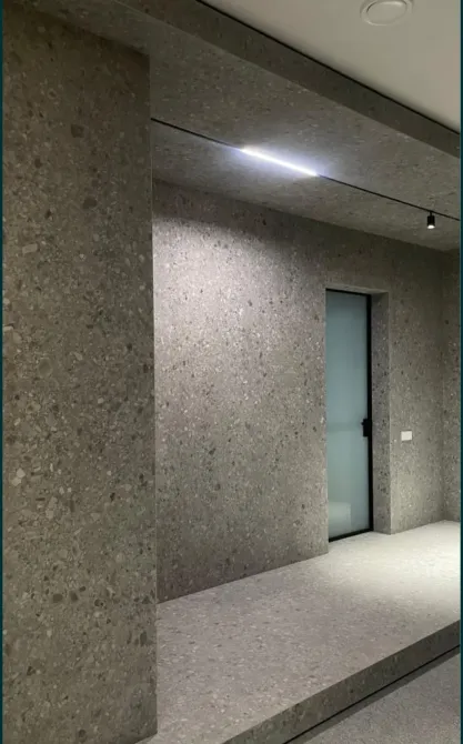 Интерьер с бетонными стенами и полом, освещённый потолком