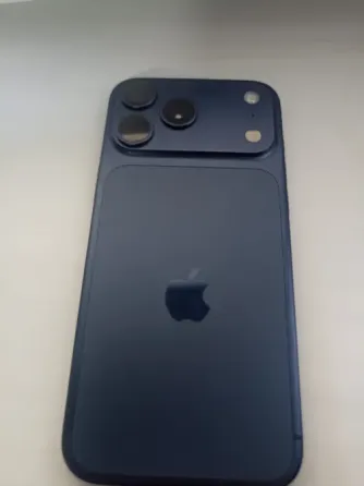 Ақ фондағы көк смартфон, артқы панелінде Apple логотипі бар. Құрылғыда екі камера және жарқыл көрінеді.