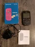 Nokia Asha 200 телефоны - қуаттау құрылғысымен және нұсқаулықпен оралған
