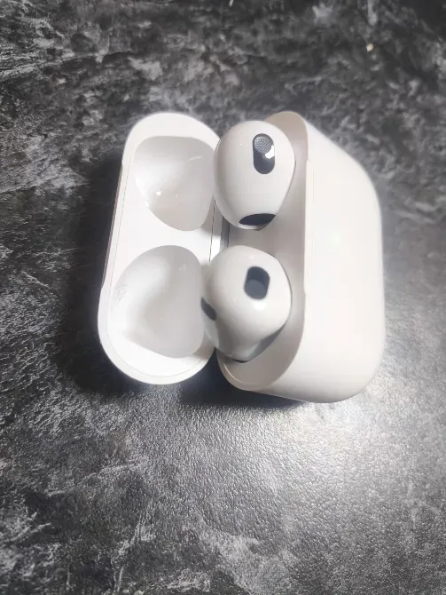Вид на AirPods, расположенные в зарядном кейсе